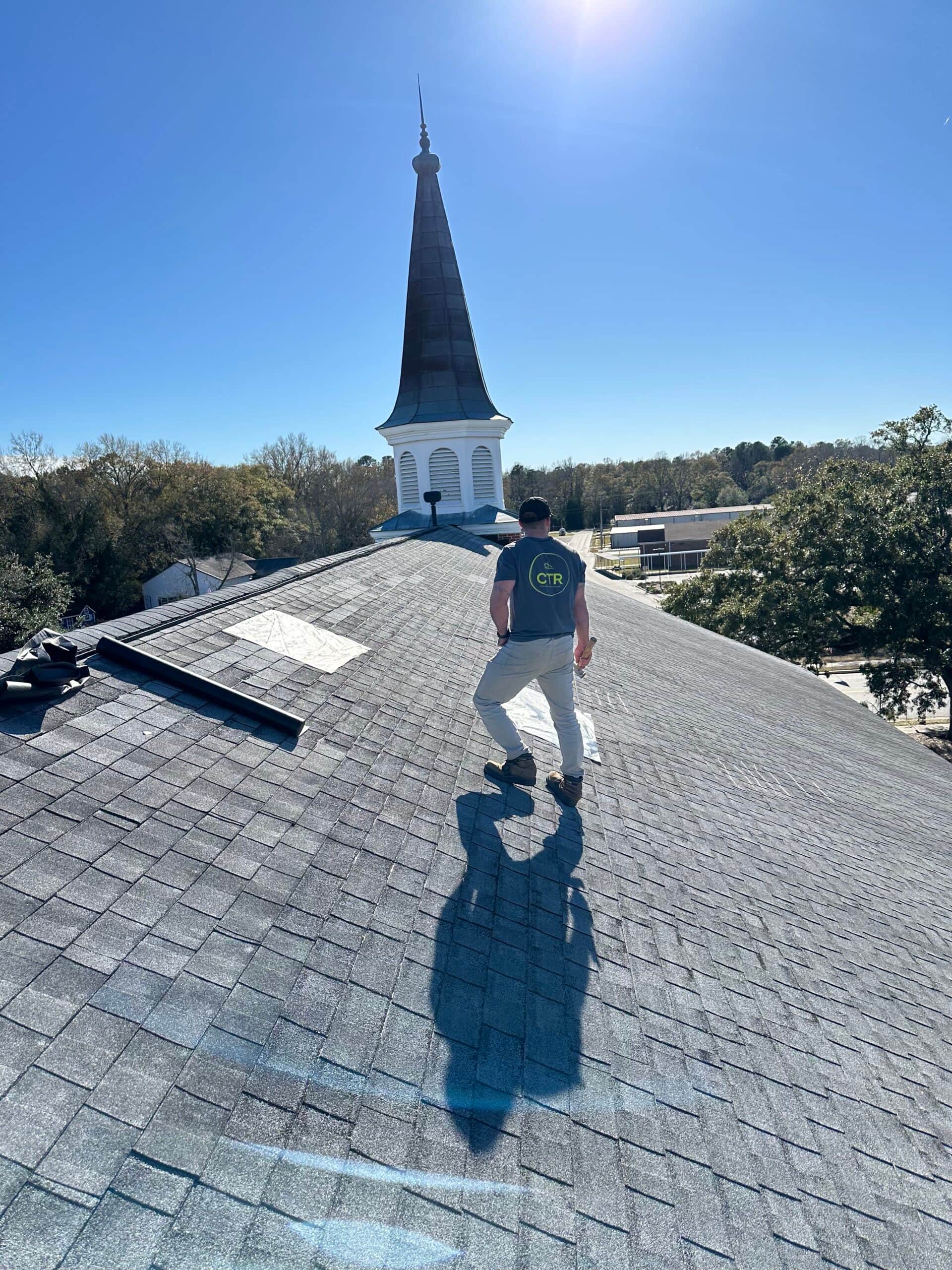 man working on roof commercial
